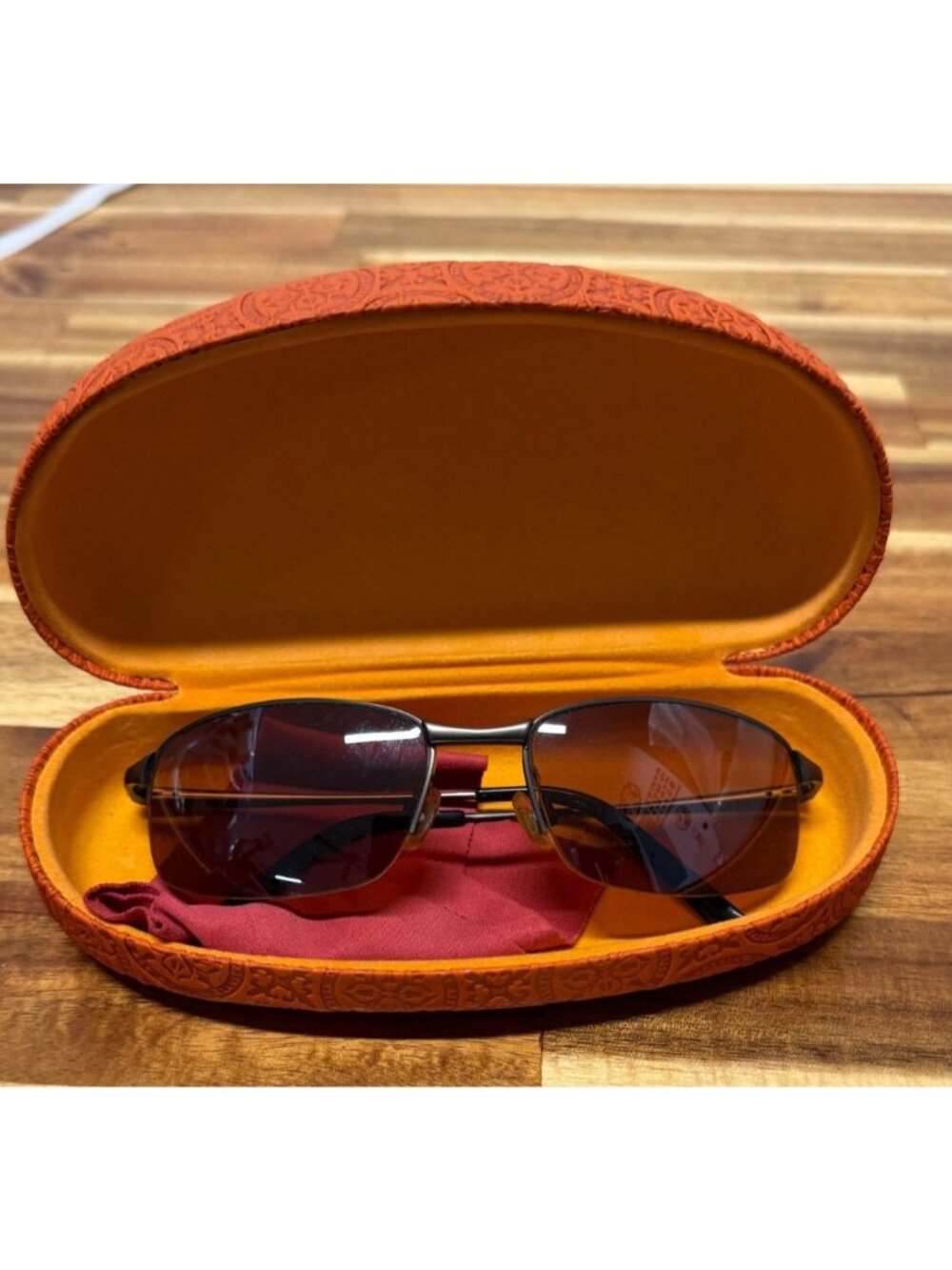Nice pair of sunglasses with hard embossed case, cleaning cloth